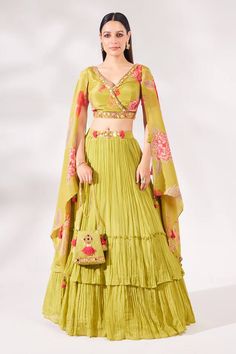 Green padded top with floral print and embellished with cutdana, sequins and beads embroidery. Paired with attached cancan ruched skirt and matching bag. - Aza Fashions Bollywood Style Green Choli For Spring, Fitted Choli With Dupatta For Spring, Designer Georgette Sets For Festive Occasions, Festive Designer Georgette Sets, Designer Festive Sets In Georgette, Traditional Green Choli For Spring, Bohemian Green Lehenga With Floral Embroidery, Bollywood Style Choli With Traditional Drape For Spring, Fitted Choli With Traditional Drape For Spring