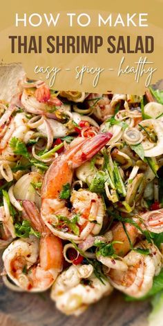 the shrimp salad is ready to be eaten on the table with text overlay that reads how to make thai shrimp salad easy - spicy - healthy