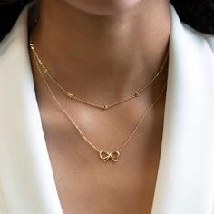 This elegant Gold Vermeil necklace features tiny hearts on a delicate diamond-cut cable chain. Pair it with other necklaces from this collection. Our patented connectors let you easily link and layer necklaces in any order you desire. Hearts width 0.11in(3mm) Adjustable chain: 15-18in(38-46cm) Gold Vermeil Spring clasp closure Hypoallergenic, lead and nickel free #112 Elegant Everyday Charm Necklace With Rolo Chain, Dainty Charm Necklaces With Cable Chain For Anniversary, Delicate Rolo Chain Necklace, Dainty Layered Necklace With Cable Chain, Everyday Delicate Infinity Chain Necklace, Elegant Rose Gold Layered Necklace With Delicate Chain, Heart Pendant Necklace With Double Chain For Gift, Dainty Layered Necklace With Satellite Chain, Dainty Charm Necklace For Layering