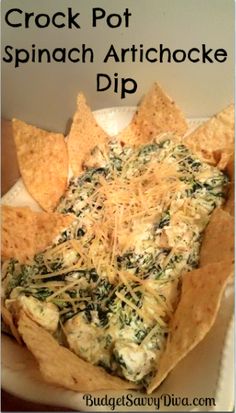 a box filled with tortilla chips covered in cheese and spinach toppings