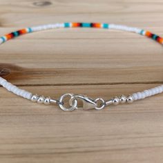 The Sunrise Dainty anklet is the same beautiful design as the original but with smaller beads that still make a statement! This ombre of colors is just what you need for a fun day in the sun. All anklets are customizable to the size you need so please be sure to measure your ankle where you want your anklet to sit and order accordingly! This high quality beaded anklet is finished with sterling silver accents, secured with a sterling silver lobster claw and made with glass beads that can stand th Adjustable White Anklets With Colorful Beads, White Beaded Anklets With Round Beads, White Beaded Chain Anklets As Gift, White Beaded Chain Anklets For Gift, Adjustable Anklet With Lobster Clasp, Festival Anklets With Beaded Round Beads Chain, Festival Anklets With Beaded Chain, White Beaded Anklets For Festival, White Beaded Festival Anklets