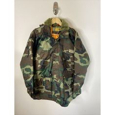 Vintage Drexlite Big J  Men M (no sizing tag please review measurements for fit)  Camo Jacket Nylon Waterproof 90s  Hooded Rain Jaxket  Lined  Measures Approx  Armpit to armpit 23.5 inches  Shoulder to hem 31 inches  Shoulder to shoulder 22 inches  Shoulder to cuff 22 inches  Condition Very Good, light general wear  Any questions measurements or pictures please let me know Casual Winter Camping Raincoat, Casual Winter Raincoat For Camping, Winter Nylon Windbreaker With Storm Flap, Winter Camouflage Nylon Outerwear, Streetwear Hooded Parka With Storm Flap, Long Sleeve Windbreaker With Storm Flap For Streetwear, Winter Streetwear Raincoat With Storm Flap, 90s Hooded Windbreaker For Hiking, Camouflage Urban Windbreaker For Outdoor