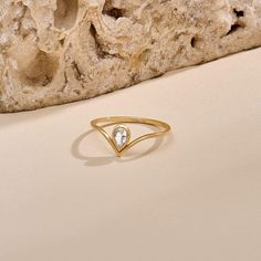 Our Diamond Pear Drop Chevron Ring features a bezel-set pear diamond, radiating brilliance. Framed by the graceful curve of the chevron motif, this ring exudes sophistication and modern allure. Its unique blend of classic charm and contemporary flair makes it a versatile statement piece that elevates any ensemble, from casual to formal occasions. - Made in 14k Solid Gold - Decorated with handset 0.17ctw white diamond - Diamond Color and Clarity: G Color SI clarity - Band Width: 0.95 mm / 0.04 inches - Top Width: 7.72 mm / 0.30 inches - Thickness: 1.30 mm / 0.05 inches - This product comes with iconic Norm Jewels gift box Elegant Pear-shaped Ring With Single Diamond, Modern Teardrop Diamond Ring For Anniversary, Elegant Teardrop Ring With Single Diamond, Elegant Teardrop Single Diamond Ring, Modern Teardrop Diamond Ring For Formal Occasions, Modern Teardrop Diamond Ring For Formal Events, Modern Teardrop Rings With Rose Cut Diamonds, Modern Rose Cut Pear-shaped Diamond Rings, Elegant White Drop-shaped Rings