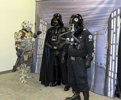 two men dressed as darth vader and stormtrooper are standing next to each other