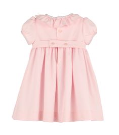 The Casero & Associates Silverstone Flower Smock Dress in Pink is the perfect dress for your little girl. With its delicate smocked design and charming ruffle collar, your baby or toddler will be the epitome of elegance. Make them feel like a true princess in this pretty in pink dress. Spring Dress With Ruffled Collar For Dress-up, Cute Dresses With Ruffle Hem And Ruffled Collar, Pink Dresses With Ruffled Collar For Spring, Classic Spring Dress With Smocked Back, Cotton Smocked Dress With Ruffles For Baptism, Elegant Smocked Ruffle Dress For Baptism, Pink Smocked Dress With Ruffle Hem For Garden Party, Cute Ruffled Collar Dress For Dress-up Occasions, Pink Daywear Dresses With Smocked Cuffs