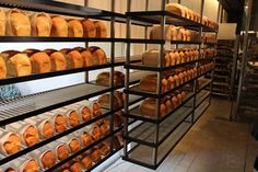 the shelves are full of breads and other baked goods for sale at the bakery