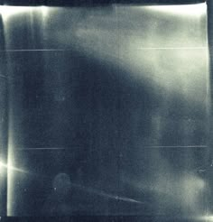 an old black and white photo of a person in the dark with their back to the camera