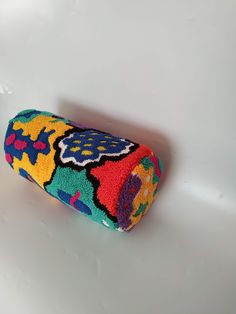 a colorful object is sitting on a white surface