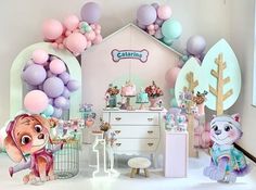 a room filled with lots of balloons and stuffed animals on the floor next to a dresser