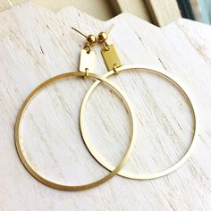 "This pair of modern big hoop earrings with nickel-free post backs are a new addition to our summer offerings. The brass is hand brushed to a golden shine and then sealed to prevent tarnish. I love the cleanliness and brightness of this collection. They feel light-hearted and ready for summer fun. Nickel free earrings.  Ready to ship. Measurements:  Hoop Diameter  2.25\" Drop 3.25\" Handmade in Milwaukee, WI. Find the rest of our Ready To Ship Jewelry Here: https://www.etsy.com/shop/permanentbag Colored Boots, Big Hoop Earrings, Nickel Free Earrings, Minimalist Gifts, Wristlet Purse, Free Earrings, Milwaukee Wi, Free Post, Brushed Brass