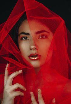 a woman with red veil over her head