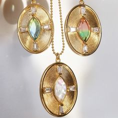 This glowing pendant features a center Marquise gemstone and rays with CZ baguettes. The pendant is 22mm x 30mm, and features an opalescent Cracked Mother of Pearl Box chain is 16" long with a 2" extender. Tarnish resistant, heavy 14K Gold over Brass A 14K gold filled chain upgrade is available, please choose "gold filled chain" from the selection box. Choose from 16"-18", or 24" long Watermelon Quartz, Suspender Earrings, Green Watermelon, Gold Coin Necklace, Oval Necklace, Coin Pendant Necklace, Necklace Layering, Medallion Necklace, Gold Coin