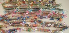 many different colored beads and bows on a table