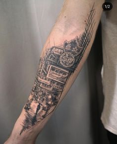 a man's arm with a black and white drawing of a train on it