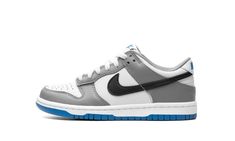 The Nike Dunk Low GS "Grey/Blue" is the youth sizing of the retro basketball shoe with a timeless color scheme.  The shoe’s upper features a white leather base with grey leather overlay panels.  A black leather Swoosh logo appears on the mid-panel while “Nike” branding is embroidered on the heel and printed on the tongue tag.  A white midsole and grey outsole put the finishing touches on the colorway.  Release date: September 15, 2023 Dunk Low Nike, Retro Basketball Shoes, Nike Branding, Retro Basketball, Light Photo, Nike Brand, Grey Light, Swoosh Logo, Nike Kids