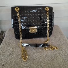 Invece -Made In Italy, Black Embossed. Genuine Patent Leather, Cross Body/ Shoulder Bag. 2-Way Gold Plated Chain Strap With Shoulder Protectors. Turn Lock Flap Close. Adjustable Detachable Strap. Color- Black, Gold Plated Hardware. No Rips Or Tears See Pictures For More Details Measurements 9" 1/2 W 8" 1/2 H 3" 1/2 D Formal Black Shoulder Bag With Gold-tone Hardware, Modern Black Shoulder Bag With Gold-tone Hardware, Black Satchel With Gold-tone Hardware Shoulder Bag, High-end Black Shoulder Bag With Gold-tone Hardware, Black Shoulder Bag With Gold-tone Hardware For On-the-go, Leather Cross, Chain Bag, Chain Bags, Gold Plated Chains