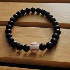 A Bracelet For The Baseball Fan. Black Matte Onyx Beads Baseball Bracelet 8 Inch. Unisex Hand Model Has A 6 Inch Wrist. 8mm Black Beads. Father's Day, Brother, Sister, Father, Husband, Sports Fan. Baseball Bracelet Diy, Baseball Mom Bracelet, Baseball Bracelet, Bracelets Black, Moms Bracelet, Hand Model, Baseball Fan, Mens Accessories Jewelry, Onyx Bead