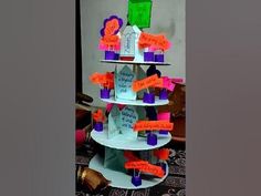 a three tiered cake with lots of writing on it's sides and decorations around the edges