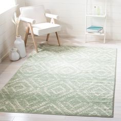 a white chair sitting on top of a wooden floor next to a green area rug