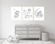 two posters on the wall above a dresser in a baby's room with a crib and rocking horse