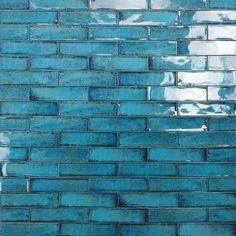 a blue brick wall that has been painted with white paint and is being used as a background