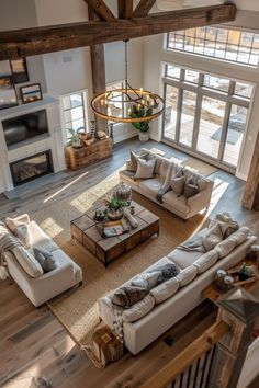 an aerial view of a living room with couches, tables and fireplace in it