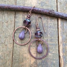 Small purple dangle drop earrings. Lightweight, everyday Czech glass earrings with rustic teardrop dangle and antiqued copper.Small, light-weight copper and Czech glass earrings that are perfect for your summer jewelry collection! The focal piece is a beautiful, faceted purple Czech glass rondelle shaped bead and small glass teardrop dangle in an antiqued copper ring.Product overview:- Made with Czech glass and antiqued copper- Total hanging length is 2", the ring is the diameter of a penny- Sma Artsy Earrings, Purple Drop Earrings, Diy Leather Earrings, Orange Jewelry, Glass Drop Earrings, Copper Accents, Copper Ring, Purple Earrings, Earrings 3