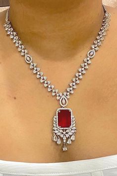 Gorgeous fine quality imitation jewellery  CZ Red with CZ diamonds studded necklace with white gold rhodium plating and matching Earrings Item contains: Necklace and earrings AAA quality cubic zirconia used. Highest quality and craftsmanship Necklace Fitting is adjustable Earrings Closure: Pushback Necklace Closure: chain with Hook Details-  -Handmade item -Delivery from a small business in India -Materials: white rhodium, stones, cz, zircon, American diamond -Jewellery type: Earrings, Necklace Red Diamond Necklace With Brilliant Cut, Red Cubic Zirconia Jewelry Sets For Celebration, Red Cubic Zirconia Jewelry Sets, Dazzling Ruby Necklace With Diamond Cut, Red Diamond Cut Necklace, Red Diamond Cut Necklace For Formal Occasions, Diamond White Ruby Necklace With 17 Jewels, Formal Red Diamond Cut Necklace, Fine Jewelry Red Diamond Necklace With Brilliant Cut