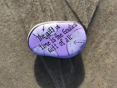 a painted rock with the words, the gift of time is the greatest gift of all