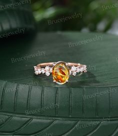 an orange and white diamond ring sitting on top of a green tire treading surface