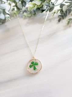 This four leaf clover necklace features a small green four leaf clover encased within jewelry grade resin. Our Shamrock necklace is the perfect accessory for St Patricks Day or lucky charm any day of the year! Complete your Saint Patricks day outfit with this cute St Patrick necklace! This beautiful botanical necklace features an open back bezel and comes in your choice of gold or silver. We include gold or silver foil flakes in the resin for extra sparkle. The size of the four leaf clover will vary slightly.  Your necklace will arrive on a necklace card inside a cute cloth bag. Ready to be gifted! We can include a gift note in your package when shipping directly to the recipient. This lovely terrarium jewelry is a great gift for her. The real flower necklace is perfect for your girlfriend Botanical Necklace, Shamrock Necklace, Cottagecore Jewelry, St Patrick's Day Outfit, Terrarium Jewelry, Four Leaf Clover Necklace, Saint Patricks, Clover Necklace, Cloth Bag