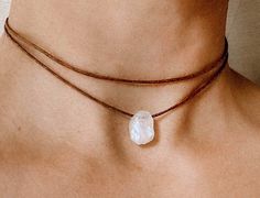 "As a stone for \"new beginnings\", moonstone is a stone of inner growth and strength. It promotes intuition, gives dreams and leads to balance.  This is a raw moonstone choker in a minimalistic look. Fully adjustable with a sliding bead on a high quality brown cotton cord.  ✦ MORE COLORS follow the links below ✦ BLACK https://www.etsy.com/de/listing/1534647969/roher-mondstein-choker-mondstein?click_key=663ae96dacc0e2f8ed138736038cab763e64a8ba%3A1534647969&click_sum=677c964f&ref=shop_home_active_29&frs=1 BEIGE https://www.etsy.com/de/listing/1534641915/roher-mondstein-choker-mondstein?click_key=e341cd911f44d6b0e493ff3f416987b7132032ed%3A1534641915&click_sum=fd7fa706&ref=shop_home_active_30&frs=1 ✦ MATERIAL | COLOR ✦ Raw moonstone Stone size: 12-15mm BROWN waxed cotton cord ✦ LOOK ✦ Two Lay Dainty Adjustable Moonstone Necklace, Bohemian Crystal Necklaces With Raw Stone, Bohemian Adjustable Crystal Necklaces With Raw Stone, Adjustable Moon Charm Jewelry For Meditation, Adjustable Gemstone Choker Necklace, Minimalist Moonstone Crystal Necklace For Healing, Dainty Adjustable Crystal Necklaces With Natural Stones, Adjustable Spiritual Crystal Necklaces With Raw Stone, White Adjustable Crystal Gemstone Necklace