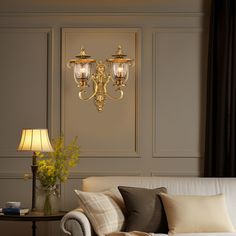 a living room filled with furniture and a chandelier hanging from the side wall