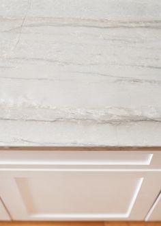 a white marble counter top in a kitchen