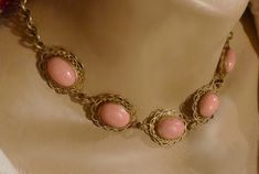 "An elegant Czehoslovakian choker necklace in the Victorian style. Five glass coral cabochons with lacy gilt filigree settings look like real, delicate colored salmon coral pieces. The links between the coral pieces are also elaborate with decoration. A charming costume jewelry necklace from the last century. Dimensions: approx. length 14 1/4\" (36.20cm ) width 3/4\" (1.91cm) Weight: approx. 1.10 oz, 31.16 g Metal: gilt Gemstone: glass--faux coral cabochons Style: choker, Victorian style Age: ea Small Pearl Ring, Glass Coral, Blue Dangle Earrings, The Coral, Rose Gold Wedding Bands, Garnet Necklace, Costume Jewelry Necklaces, Rose Gold Wedding, Choker Necklaces