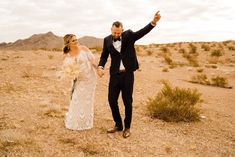 a newly married couple walking through the desert