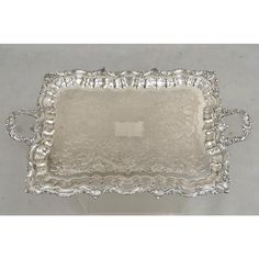 an ornate silver tray with handles