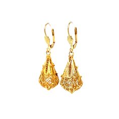 These Intricate Filigree Mid-Century Drop Earrings feature a vintage teardrop chandelier design 14 karat yellow gold. Royal filigree metalwork wears around each pear-shaped charm. Two seashell engravings decorate the front of the lever backings. A milgrain rope and openwork design. The drops measure 1.75 inches long and .25 inches wide. Romantic, radiant, and truly unique. French-inspired Mid-Century drops to lighten up your look! Yellow Gold Historical Drop Earrings, Historical Yellow Gold Drop Earrings, Yellow Gold Drop Earrings With Historical Design, 14k Gold Victorian Filigree Earrings, Victorian 14k Gold Filigree Earrings, Formal Yellow Gold Drop Bridal Earrings, Yellow Gold Drop Bridal Earrings For Formal Occasions, Formal Teardrop Bridal Earrings, Formal Teardrop Pierced Bridal Earrings