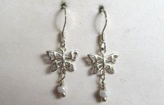 Hi there and welcome to 'In the magpie's nest' For sale - A pair of vintage 90's sterling silver butterfly shaped beaded drop dangle earrings 925     Earring type - Drop/dangle Shape - Butterfly Measurement - 3.1cm's (length inc hook) 1.1cm's (width) Backs - Hooks Metal - Sterling silver - 925 - 1.17g (marked 925 on the hooks and the reverse of the earrings) Beads - White glass bead drop Era - 1990's ------------------------------------------------------------------------------------------------ Crochet Metal, Shape Butterfly, Earrings Beads, Silver Butterfly, Butterfly Shape, Drop Dangle Earrings, Earring Type, Glass Bead, White Glass