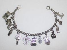 "This listing is for 1 Stainless Steel Nickle Free Cable Chain Charm bracelet, Nickle free zinc alloy charms. *This bracelet measures approx 8 \" in length. You have the option to choose other bracelets sizes and also to add an initial charm Please select the charms that you would like on your bracelet from the photo chart shown in this listing and then send me a list with the corresponding number of each charm. Maximum limit of 11 charms When purchasing a bracelet for someone other than yoursel Louisiana Jewelry, Gift Bingo, Music Bracelet, Teacher Bracelet, Travel Bracelet, Bracelet Card, Athlete Gifts, Custom Charm Bracelet, Nyc Jewelry