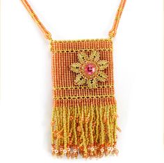 an orange beaded necklace with beads and tassels