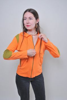 "Vintage orange zipped up hoodie, women 90s sport shirt, Size S Welcome to TARASCOMMON.ETSY.COM Unique clothing from the 20th century. Model tall - 170cm S. Sleeve - 43cm / 16.92inch; ( armpit to end of sleeve); Width - 39cm / 15.35inch; Length - 55cm / 21.65inch. All measurements are taken seam to seam while lying flat. Cotton. This item is vintage, so it can have some defects. Additional photos can be send We are glad that you are interested in lots that we sell. Wish you a good shopping! FOLL Orange Hooded Top For Streetwear, Sporty Orange Hoodie For Fall, Orange Cotton Hooded Sweatshirt, Orange Drawstring Hood Top For Fall, Orange Hooded Sporty Top, Sporty Orange Hooded Sweatshirt, Sporty Orange Hooded Top, 90s Style Long Sleeve Hooded Jacket For Fall, Orange Cotton Hoodie Top