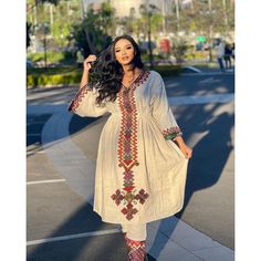 This fashionable Fetil Habesha dress is the perfect combination of traditional and modern style. The Shimena cut flatters your curves and adds a touch of elegance to the design, while the intricate Fetil embroidery on the neckline and sleeves is a true work of art, showcasing the skill and craftsmanship of Ethiopian artisans. The dress is made from high-quality fabric that feels soft and comfortable against the skin, while the modern design gives it a fresh, contemporary feel. The vibrant colors Traditional Tunic Dresses For Navratri, Beige Dress For Navratri Festival, Traditional Dabka Tunic Dresses, Bohemian Straight Kurta Dress For Eid, Traditional Tunic Dresses With Dabka Embroidery, Eid Bohemian Straight Kurta Dress, Bohemian Dresses With Dabka For Navratri, Folk Style Fitted Dress For Eid, Fitted Folk Dress For Eid