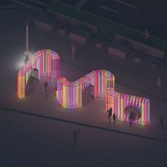 people are walking around an art installation with colorful lights