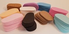 a pile of different colored cookies sitting on top of a white table next to each other