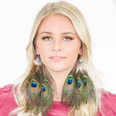 "These gorgeous peacock feather earrings will add bohemian flair to any outfit! They feature 925 sterling silver ear hooks with 5 natural peacock feathers. -925 Sterling Silver ear hooks -100% natural peacock feathers -Approximately 3\" Length -Feathers may vary slightly in size and shape {ABOUT US} Kristin Perry introduced her namesake collection of fashion forward hair accessories in 2010. The line started as an ebay store selling handmade wares to a fashion hungry customer. The brand quickly Peacock-colored Bohemian Earrings For Gift, Bohemian Peacock Earrings For Gift, Peacock Bohemian Earrings For Gift, Bohemian Peacock Earrings As Gift, Peacock Bohemian Earrings As Gift, Bohemian Feather Earrings For Party, Bohemian Party Jewelry With Feathers, Bohemian Green Earrings With Peacock Design, Bohemian Peacock Design Earrings For Party