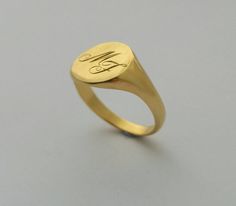 "A classic hand engraved signet ring for men or women. A beautiful 14K yellow gold signet ring. This ring will be especially beautiful as a pinky ring will look great on any finger you choose to wear it. The ring is not hollowed and has a shiny finish, also on the inside. This ring can be customized: It can be hand engraved to up to 3 letters. The engraving can be made with a font of your choosing - you can even write it in your own handwriting - nothing is more personalized than this <3 This Timeless Classic Design Signet Ring, Formal Heirloom Style Signet Ring With Round Band, Heirloom Classic Signet Ring, Heirloom Style Formal Signet Ring, Formal Heirloom Style Signet Ring, Oval Engraved Ring With Classic Design For Formal Occasions, Formal Oval Engraved Ring With Classic Design, Wedding Polished Finish Round Signet Ring, Minimalist Open Signet Ring With Engraving Option