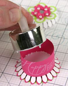 someone is making some paper flowers out of crafting material and glues them together