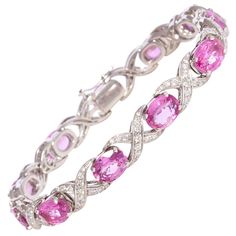 The pink sapphire and diamond bracelet features oval cut faceted sapphires of brilliant hues and crystalline texture for a total of approximately 14 carats. The design is complete with 2.00 carats of top quality diamonds (F/VVS). The bracelet was handmade by gran maestro Pasquale in 18 carat white gold in our own workshop in Italy, according to an original design by Ella Gafter. The item is one-of-a-kind and signed EG. It is shown with 2 more bracelets of the same design in the last image of the Cedric Charlier, Flexible Bracelet, Diamond Bracelet Design, Bracelets Design, Antique Bracelets, White Gold Sapphire, Colored Stones, Expensive Jewelry, Sapphire Bracelet