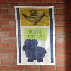 a brick wall with a sign on it that says polish folk art and an elephant